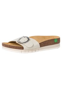 Cork-soled slide sandal featuring a cream leather strap with a silver circular buckle. Textured footbed, white rubber outsole with grip.