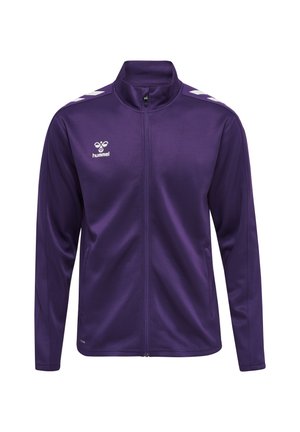 Lilla sportstrøje med fuld lynlås med hvidt logo og chevronstriber på skuldrene, lange ærmer og sidelommer.