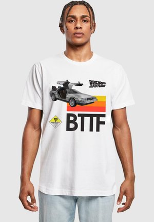 White cotton t-shirt featuring a graphic of a DeLorean car, text "BACK TO THE FUTURE," and yellow radioactive symbol. Casual fit.