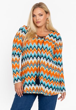 Meerkleurige blouse met lange mouwen, voorzien van een zigzagpatroon in oranje, teal, zwart en wit, met een ronde halslijn en een trekkoorddetail.
