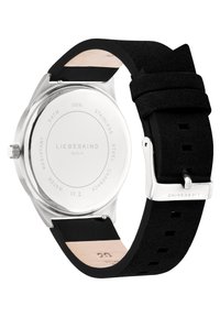 Runde Armbanduhr aus Edelstahl mit einem schwarzen strukturierten Lederarmband. Sie verfügt über einen polierten Gehäuseboden, eine wasserdichte Bewertung von 5 ATM und eine Markengravur.