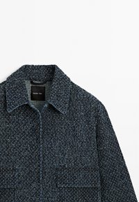 Navy textured jacket with a collar and two front pockets. Tag inside displays the brand "Massimo Dutti."