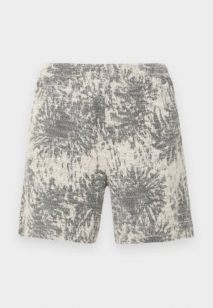 Krém és fekete színű kötött rövidnadrág, textúrával és absztrakt mintával. A rugalmas derékpánt komfortot és könnyű viselhetőséget biztosít.