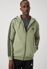 adidas Sportswear ESSENTIALS 3 STRIPES FULL ZIP - Camisola com fecho - tent green/black