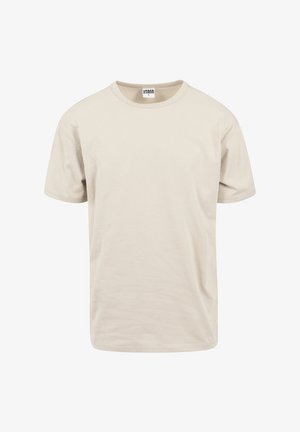 T-shirt en coton beige, manches courtes, encolure ronde, coupe décontractée. Texture lisse avec un design simple et sans ornement.
