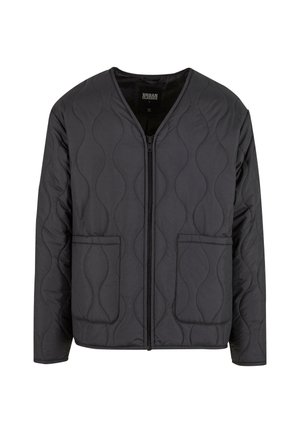 Mustaka vuorattu takki V-pääntie designilla, edessä vetoketjukiinnitys ja kaksi suurta sivutaskua. Kankaassa on tekstuuriset aaltoilevat kuviot.