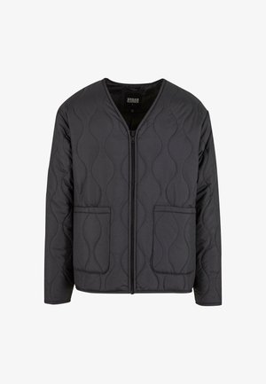 Black quilted jacket with a V-neck design, front zipper closure, and two large side pockets. Features textured wave patterns on the fabric.