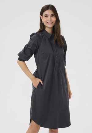 Dark gray dress made of lightweight fabric, featuring a button-down front, puffed sleeves, side pockets, and a relaxed fit with a curved hem.