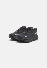 Baskets de running noires dotées d'un dessus en maille texturée, de lacets plats, d'une semelle rembourrée et d'accents de logo sur le côté. Conception à bout rond.