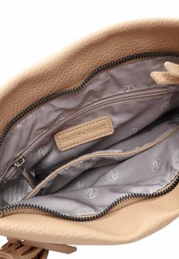 Beige leather handbag with a textured exterior, featuring an interior zip pocket and a light gray lining with a subtle pattern.