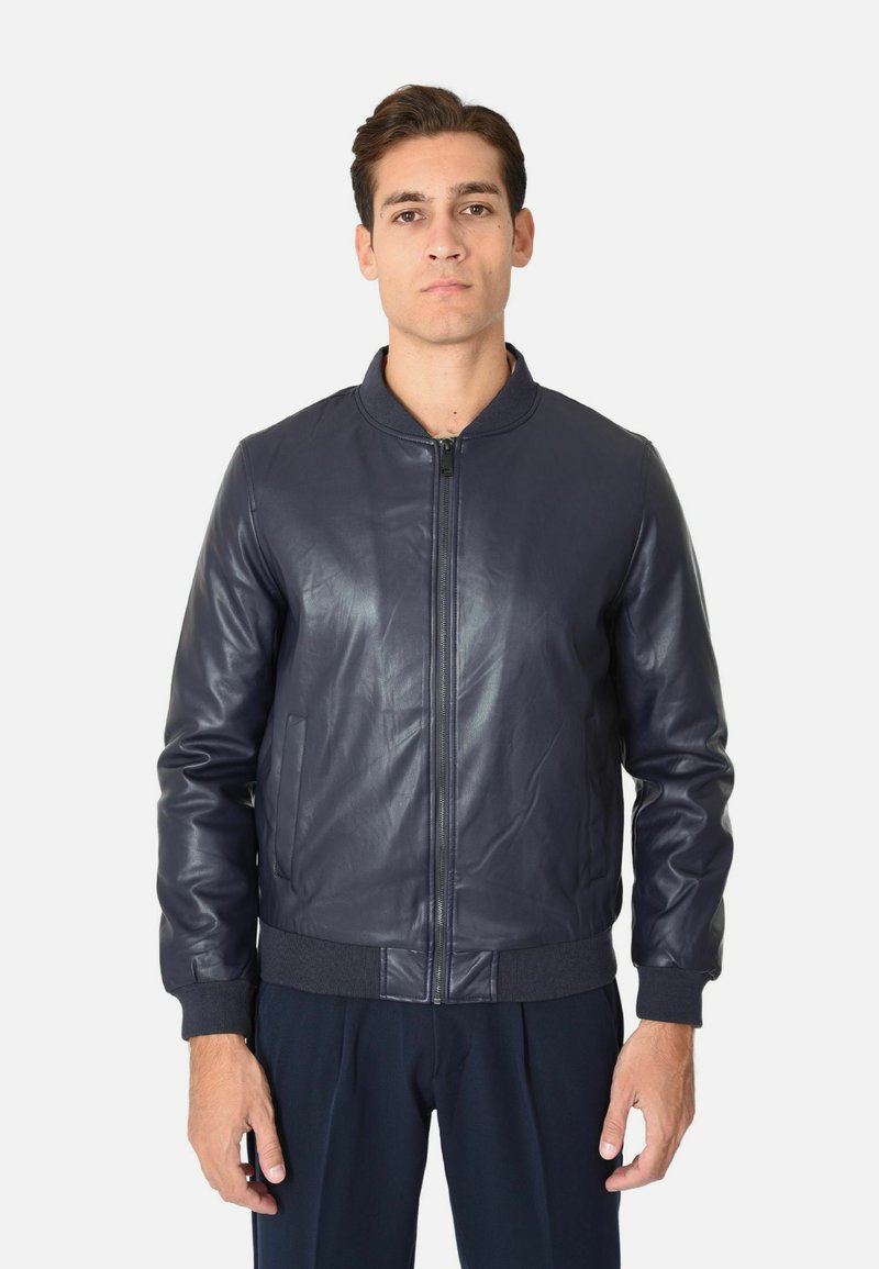 Giacca bomber in pelle blu navale con zip frontale, colletto e polsini a coste, caratterizzata da una texture liscia e tasche laterali.