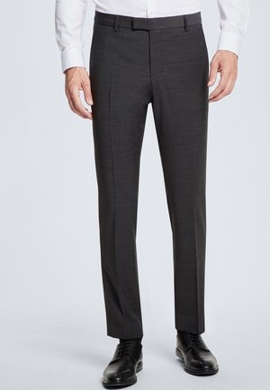 Charcoal gray tailored trousers made of textured fabric, featuring a slim fit, flat front, and detailed stitching. Paired with black dress shoes.
