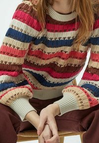 Multicolored knit sweater featuring horizontal stripes in pink, blue, brown, and beige with openwork accents and ribbed cuffs.