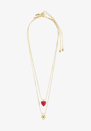 Gold-colored layered necklace with two heart pendants: one red, glossy, and the other gold, shiny. Features a delicate chain design.