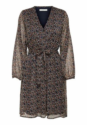 Floral print dress in sheer navy fabric, featuring long sleeves, a V-neck, and a tied waist for a fitted shape. Small, multicolored flowers detail.