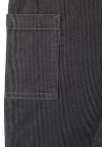 Gray corduroy fabric with vertical ridges, featuring a patch pocket on the side. Stitched detailing enhances structure and texture.