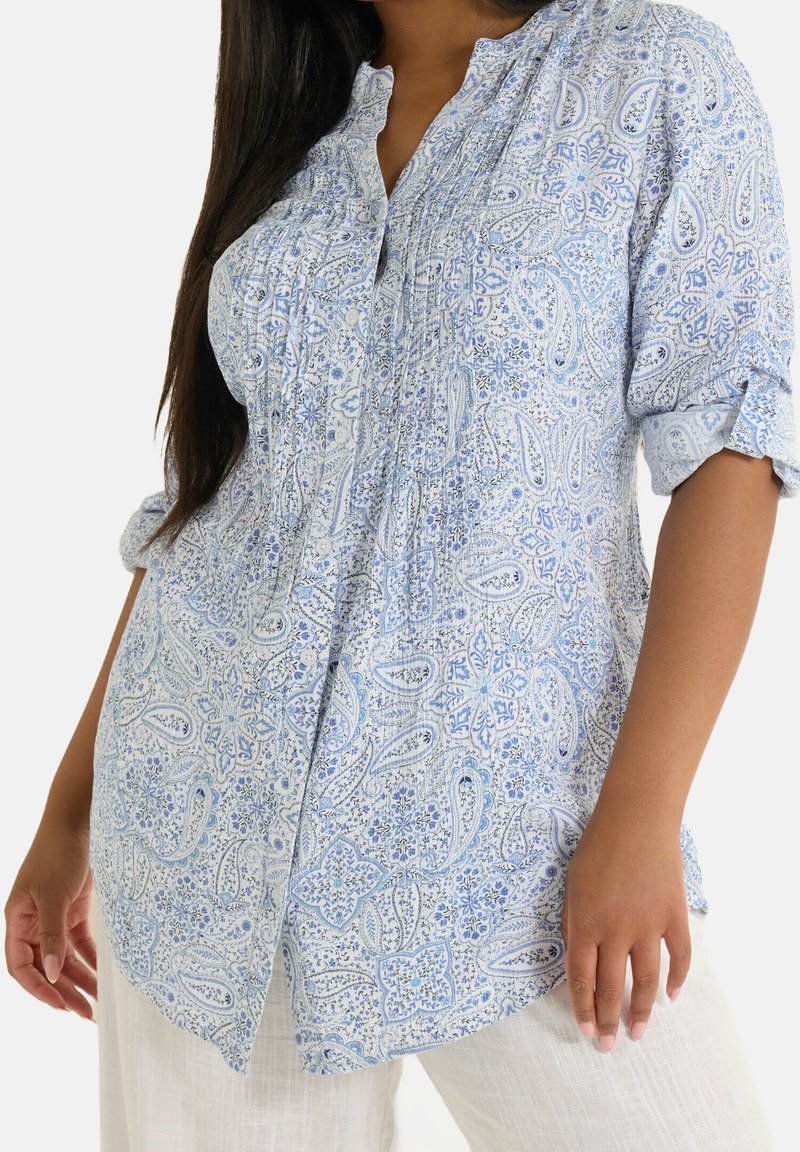 Jasnoniebieska koszula z guzikami z wzorem paisley, z plisowanym przodem i podwiniętymi rękawami. Wykonana z miękkiej, oddychającej tkaniny o luźnym kroju.
