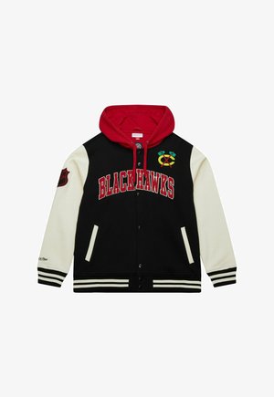 Blackhawks hoodie with black body, white sleeves, red hood, striped cuffs, snap buttons, and embroidered team logo on chest and sleeve.