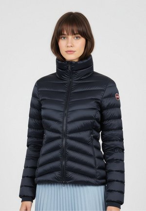 Navy puffer jacket with a high collar, ribbed stitching, and zipper front. Features a logo patch on the shoulder and smooth, glossy texture.