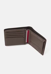 Brown leather wallet with multiple card slots and a cash compartment. Interior features a red and white striped accent. Smooth texture.