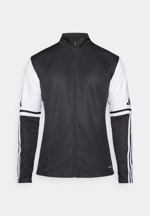 Veste de sport noire avec fermeture éclair à l'avant, manches blanches et trois rayures blanches verticales sur chaque bras. Fabriquée en matériau synthétique lisse.
