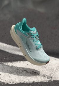 Light blue running shoe with a breathable mesh upper, cushioned sole, and detailed lacing system; features subtle textures and accents.