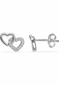 Silver heart-shaped stud earrings featuring a larger open heart design and a smaller solid heart inset, adorned with clear rhinestones.