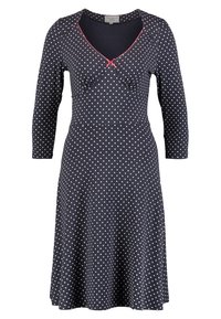 Robe à pois bleu marine avec des manches longues, décolleté en V et bordure rose. Silhouette évasée en tissu doux avec des fronces au niveau de la poitrine.