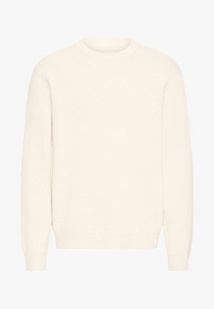 Vaalean kermaisen värinen neulepaita, jossa on pyöreä pääntie, pitkät hihat sekä ribbaus hihansuissa ja helmassa. Kangas on pehmeä ja tekstuuriltaan mielenkiintoinen.