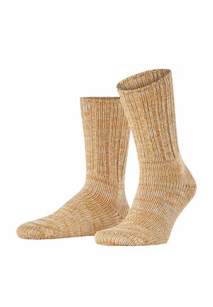 Calzini lavorati a maglia in morbido giallo e crema, con una texture a coste e altezza a metà polpaccio, adatti per un look informale o per momenti di comfort.