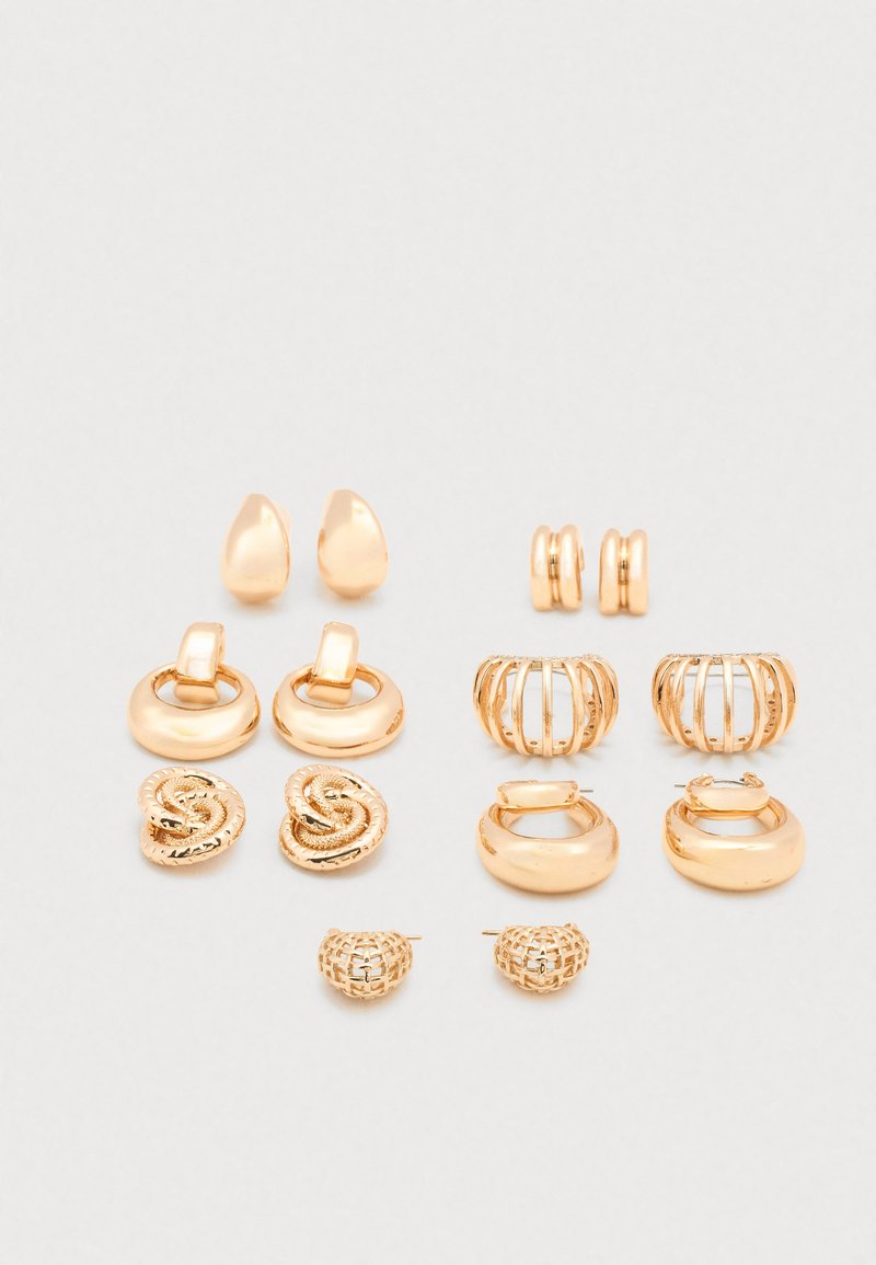 Set of gold-tone earrings featuring various designs: teardrop, hoops, textured patterns, and snake motifs. Includes studs and wire accents.