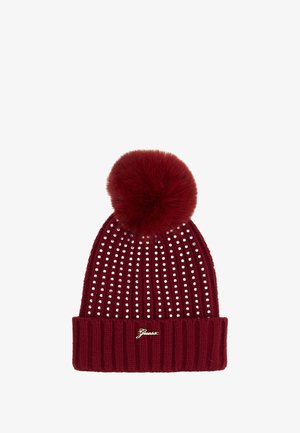 Berretto lavorato a maglia rosso con pompon in pelliccia. Presenta righe verticali di strass e un bordo a coste, con un accento in logo dorato sul davanti.