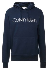 Marinblå tröja med huva, framficka, snörning i huvan och vit "Calvin Klein"-logotyp centrerad på bröstet.