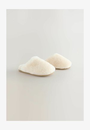 Beidzējas, pūkainas čības ar noapaļotu formu un mīkstu tekstūru. Ar platu zoli un atvērtu aizmuguri, kas nodrošina ērtu uzvilkšanu.