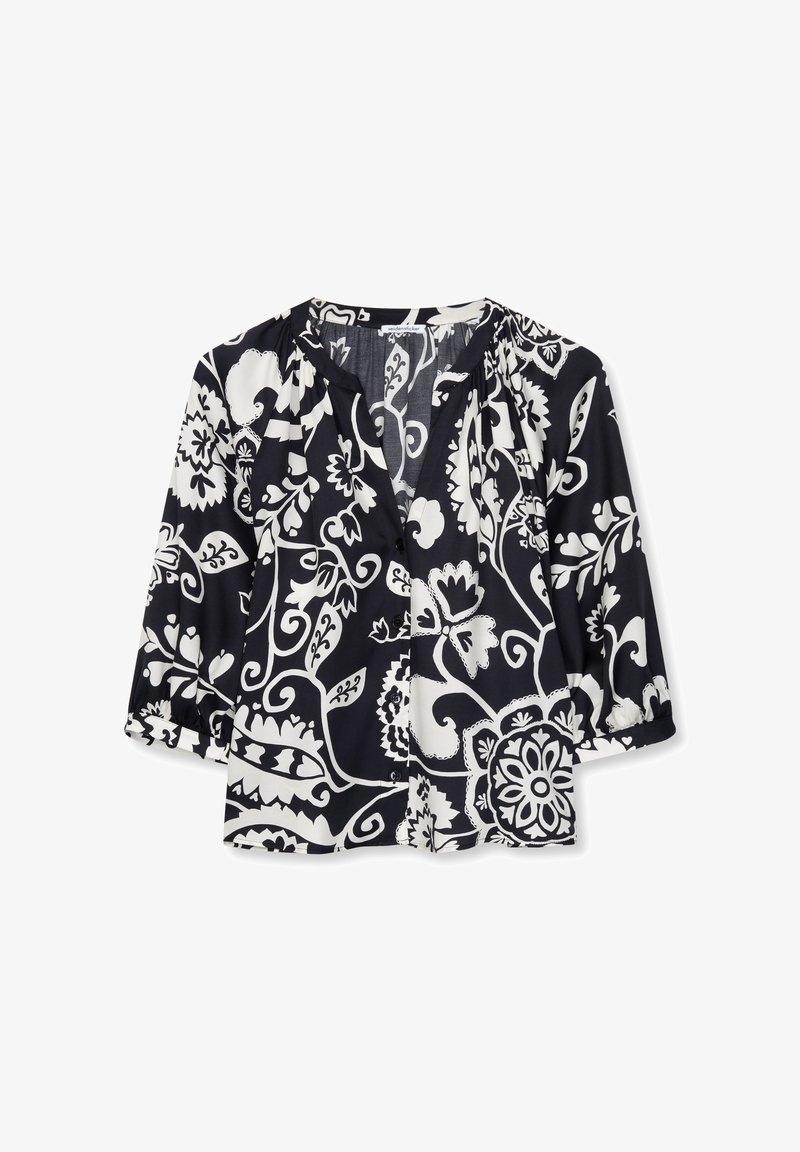 Blouse à motifs floraux en noir et blanc, manches trois-quarts, col rond et boutonnage sur le devant.