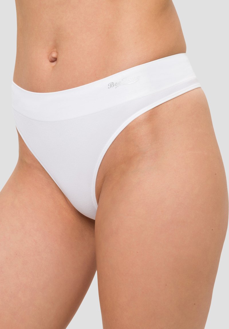 White thong underwear with a smooth, stretchy fabric. Features a wide waistband with subtle branding. Designed for comfort and minimal coverage.