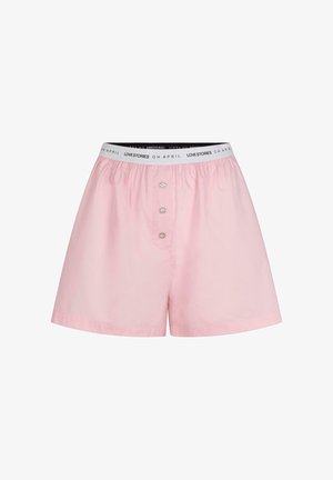 Rožinės medvilnės šortai su elastinga juosmens juosta ir logotipo atspaudu. Priekyje yra trys dekoratyviniai mygtukai ir laisvas siluetas.