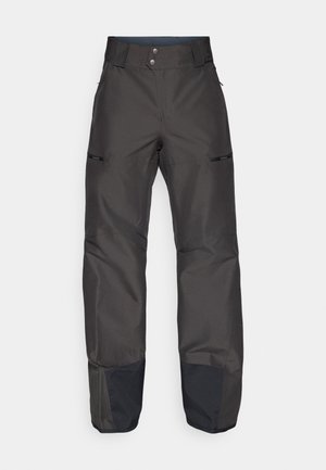 Pantalones impermeables negros de cintura alta, con dos bolsillos frontales, detalles de cremallera y puños en negro de contraste.