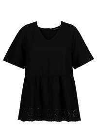 Haut noir à manches courtes avec col en V. Caractérisé par une taille froncée et un motif floral découpé décoratif le long de l'ourlet. Tissu texturé.