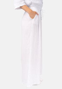 Weiße, leichte Leinenhose mit strukturiertem Stoff, Seitentaschen und einem elastischen Bund mit Kordelzug. Lockere Passform.
