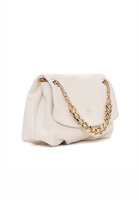 Soft beige leather handbag with a front flap and large gold chain handle, featuring a subtle embossed logo on the flap.