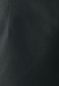 Svart tyg med en texturerad väv, som visar en slät, något matt yta och subtila variationer i nyansen. Inga mönster eller accenter närvarande.