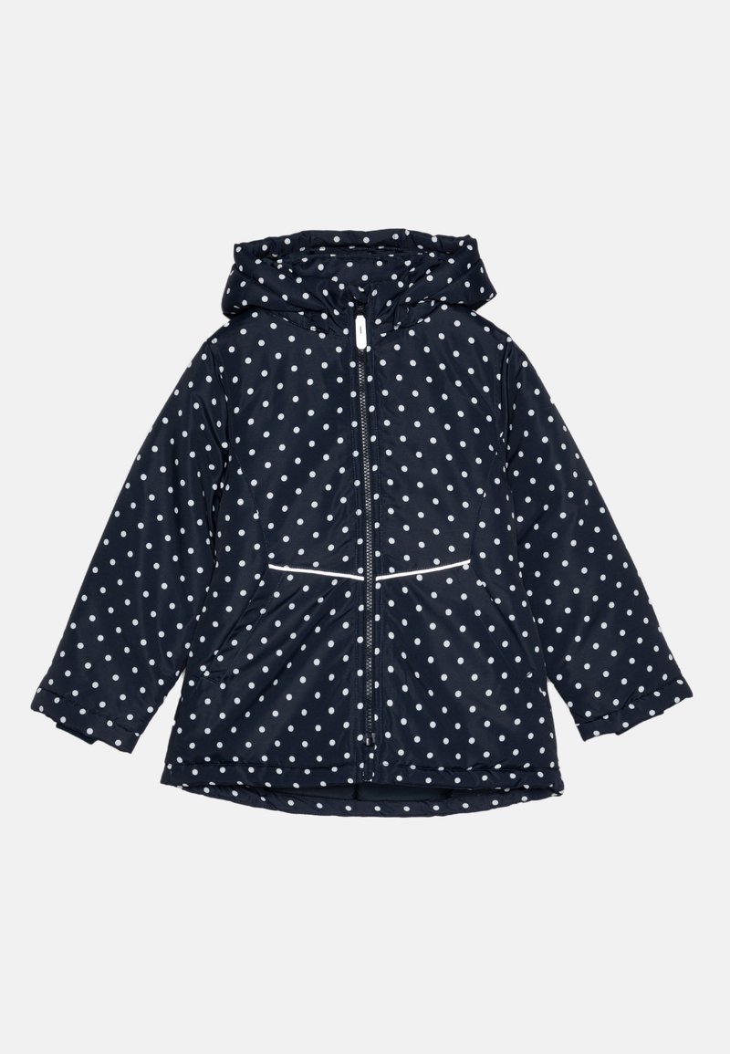 Marineblå jakke med hvide prikker, fuld lynlås, hætte og to lavere lommer. Blød, glat tekstur med kontrasterende hvide lynlås kanter.