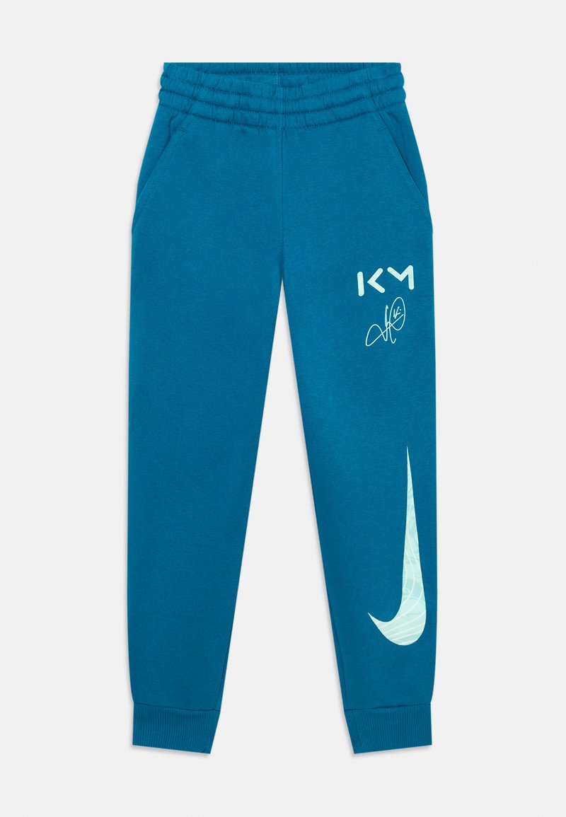 Blå bomulds sweatpants med elastisk talje, to sidelommer og et stort hvidt Nike-logo på venstre ben.