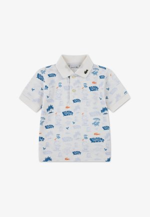 Polo blanc avec motifs bleus et orange, comprenant des palmiers et des designs ludiques. Mélange de coton avec un col classique et le logo Lacoste.