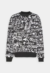 Felpa nera con una stampa grafica di testo bianco e simboli. Ha un collo rotondo e polsini a coste. Tessuto in cotone morbido.