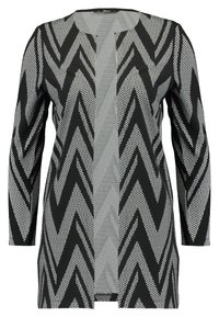 Černobílý cardigan s otevřeným předním dílem, dlouhými rukávy a výrazným cikcak vzorem.