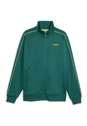Grüne Jacke mit Reißverschluss, gelben Paspeln an den Ärmeln, hohem Kragen, Fronttaschen, Puma-Logo auf der linken Brust und Aramco Formula 1 Team-Emblem auf der rechten Brust.