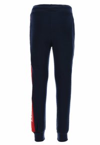 Marineblaue Jogginghosen mit einem roten Seitenstreifen, elastischem Bund und gerippten Bündchen; aus weichem, bequemem Material mit glatter Textur.