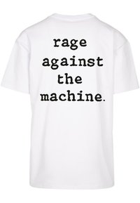 White cotton t-shirt featuring black text on the back that reads "rage against the machine." Short sleeves and a relaxed fit.